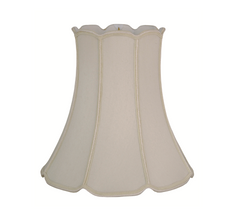 A beige V-Notch Drum lampshade with braided trim.